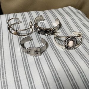 Four older cuff style bracelets